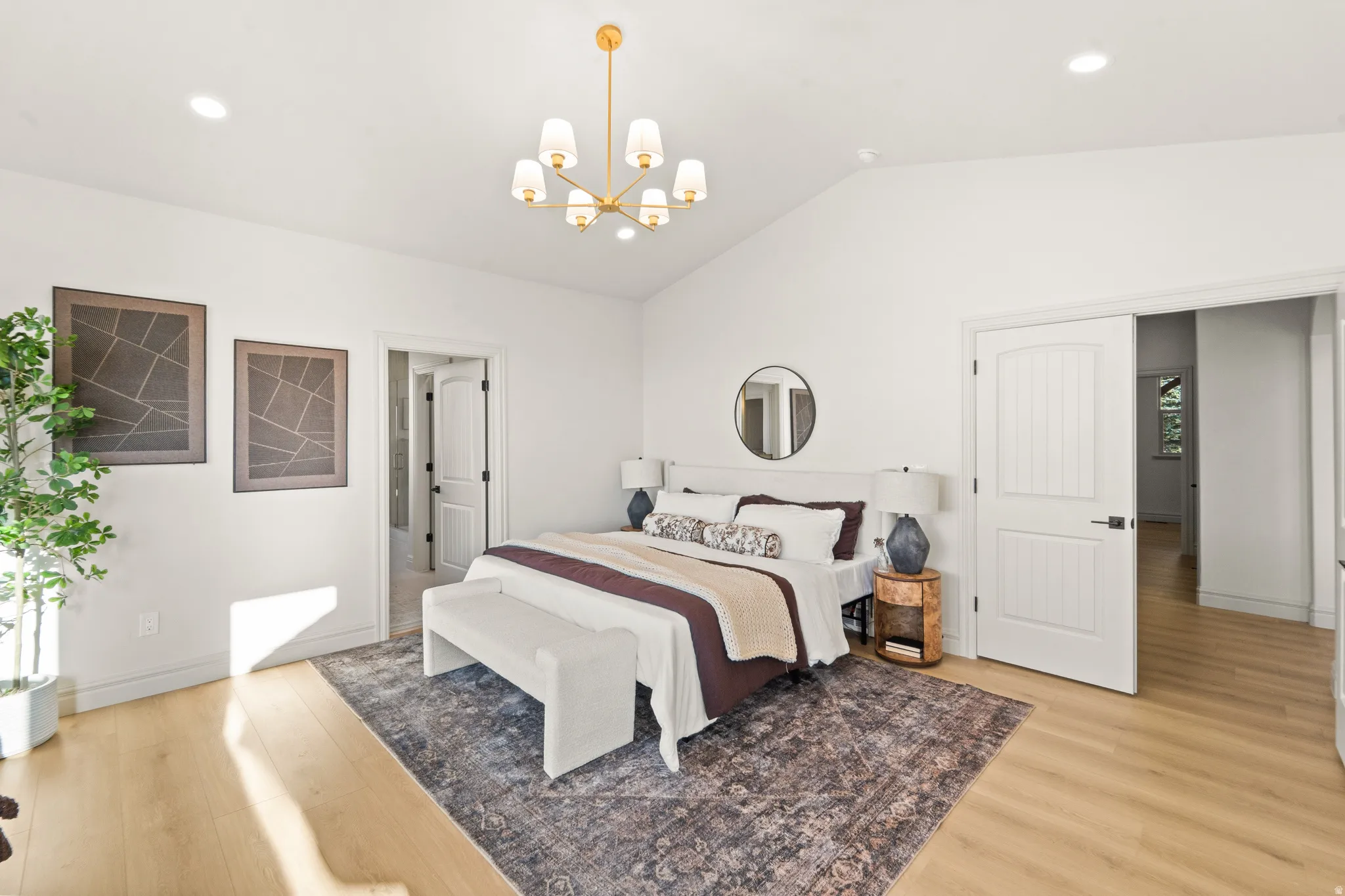 Vaulted ceiling, wood-finish flooring, recessed lighting, and a modern chandelier