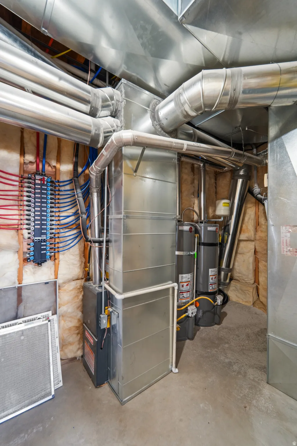 Forced air furnace, galvanized steel ductwork, hot water heaters, and PEX plumbing manifold
