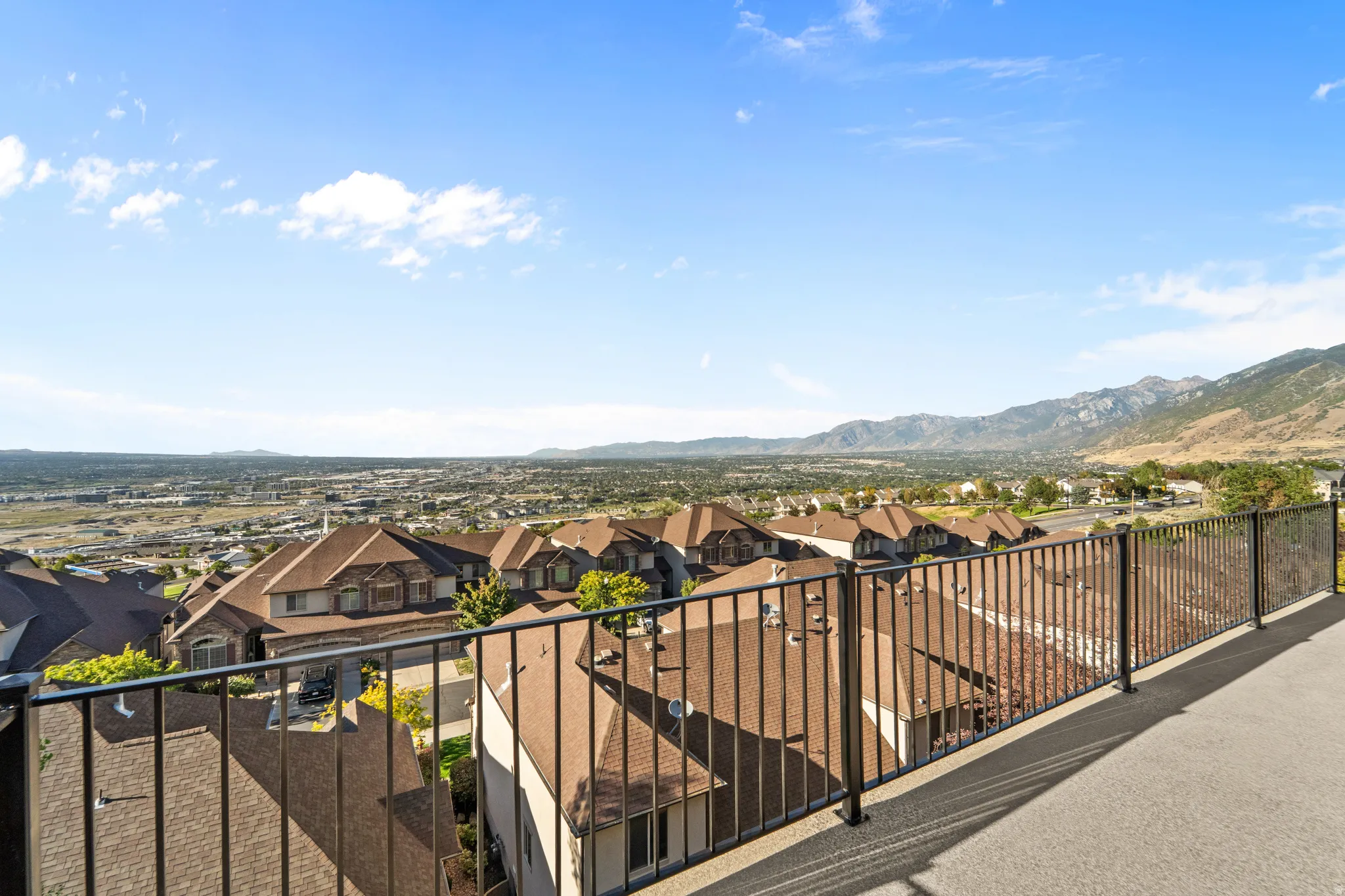 Expansive outdoor space featuring a textured surface and metal railings
