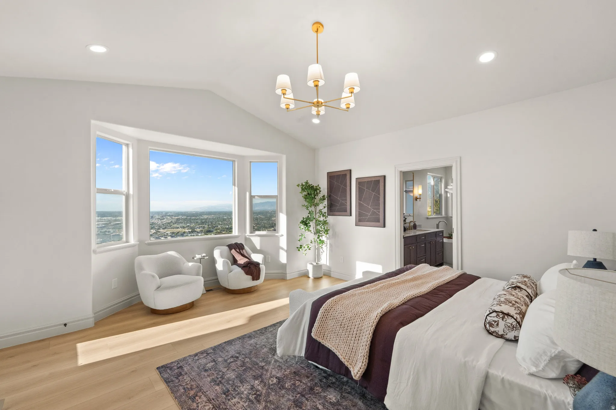 Vaulted ceiling, recessed lighting, wood-finish flooring, bay window, gold-tone chandelier