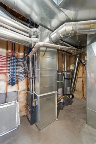 Forced air furnace, galvanized steel ductwork, hot water heaters, and PEX plumbing manifold