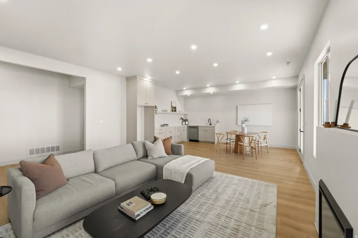 Recessed lighting, wood-finish flooring, and white walls