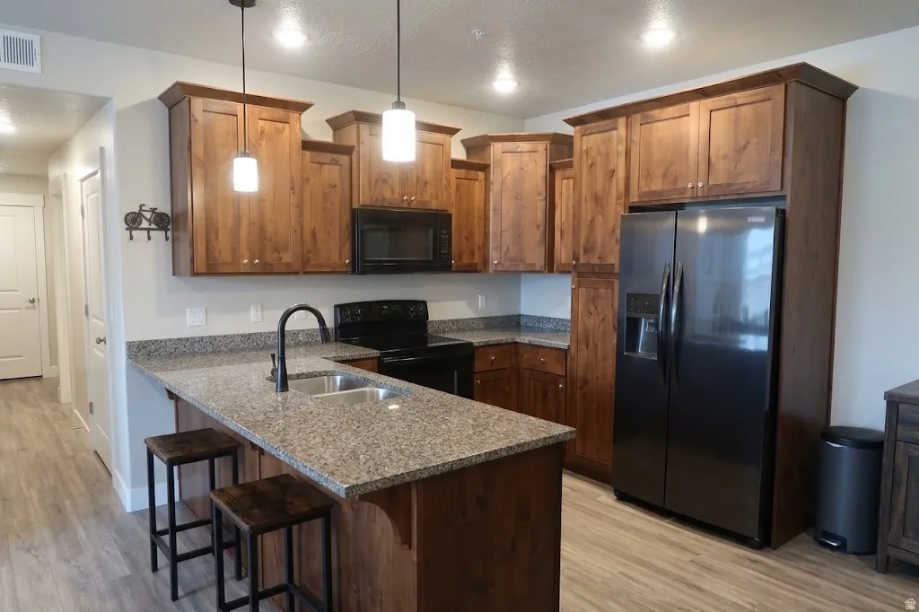 Wood-finish flooring throughout, complemented by a kitchen island with stone-look countertop
