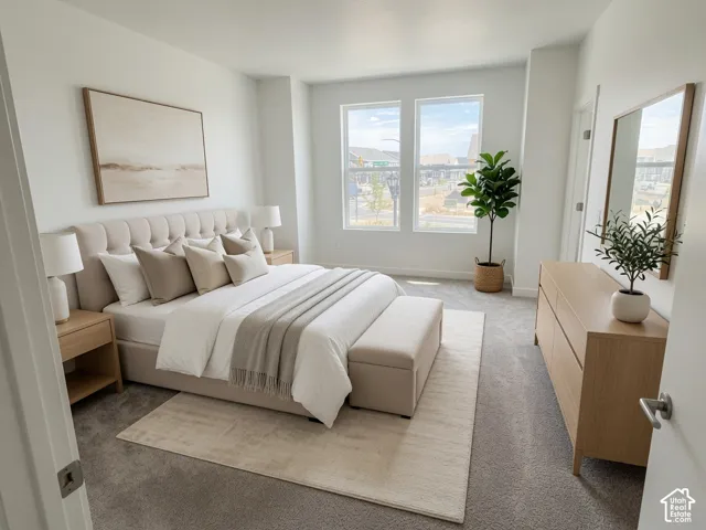 Recessed lighting illuminates the space, complemented by large windows offering abundant natural light