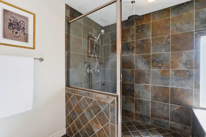 Walk-in shower with full wall and floor tiling