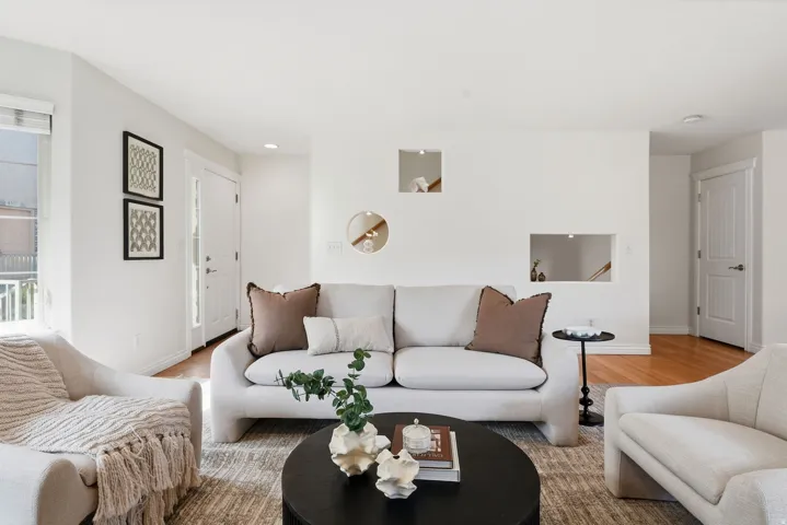 Hardwood flooring, white walls, recessed lighting, white trim, and a white paneled door