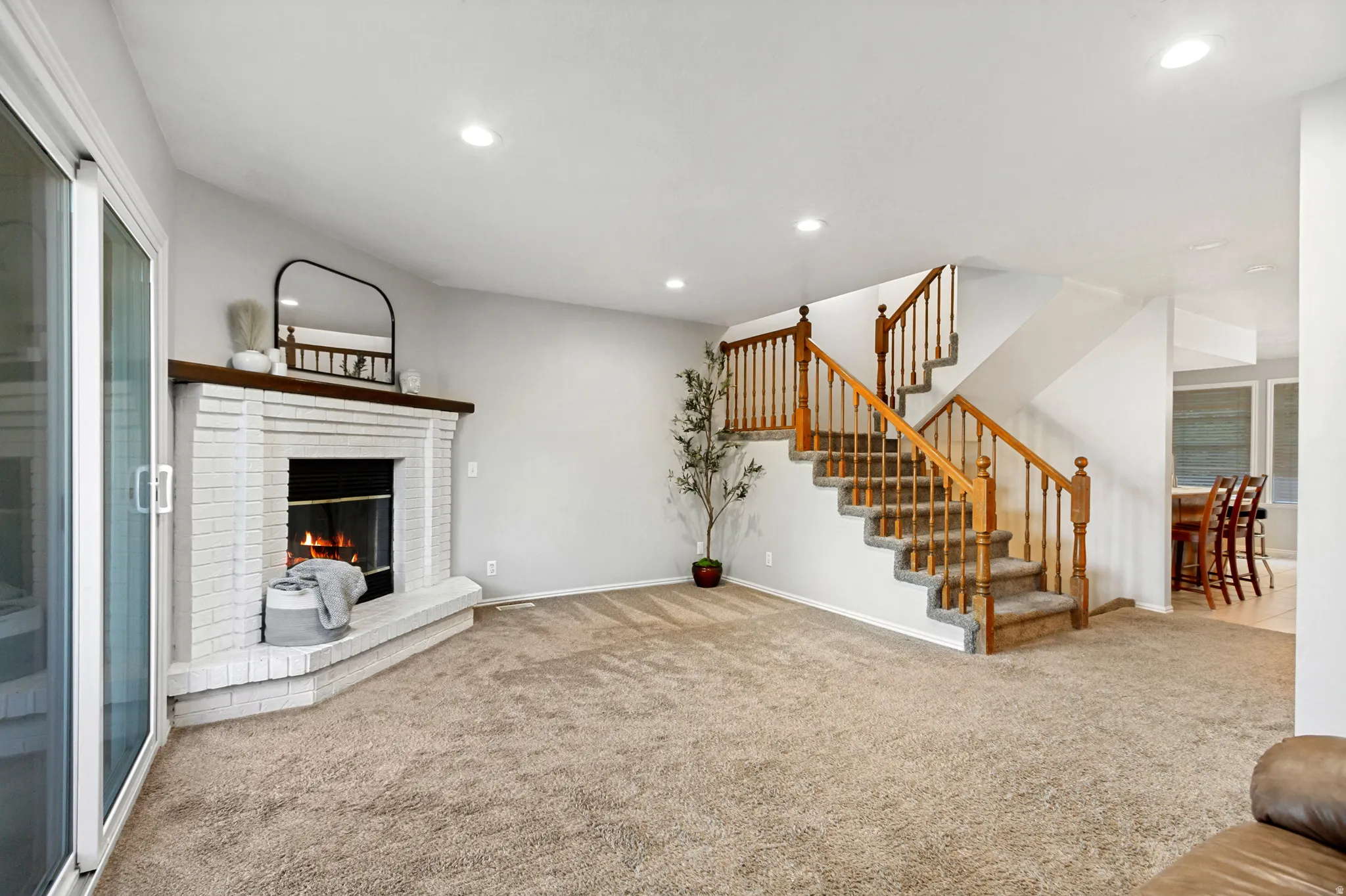 Brick fireplace with a wood mantel