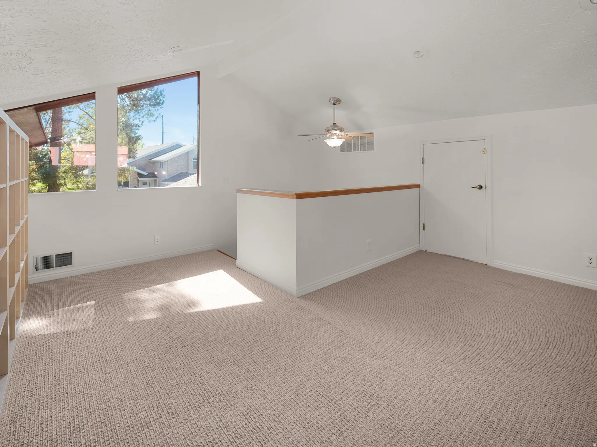 Vaulted ceilings and large windows in loft