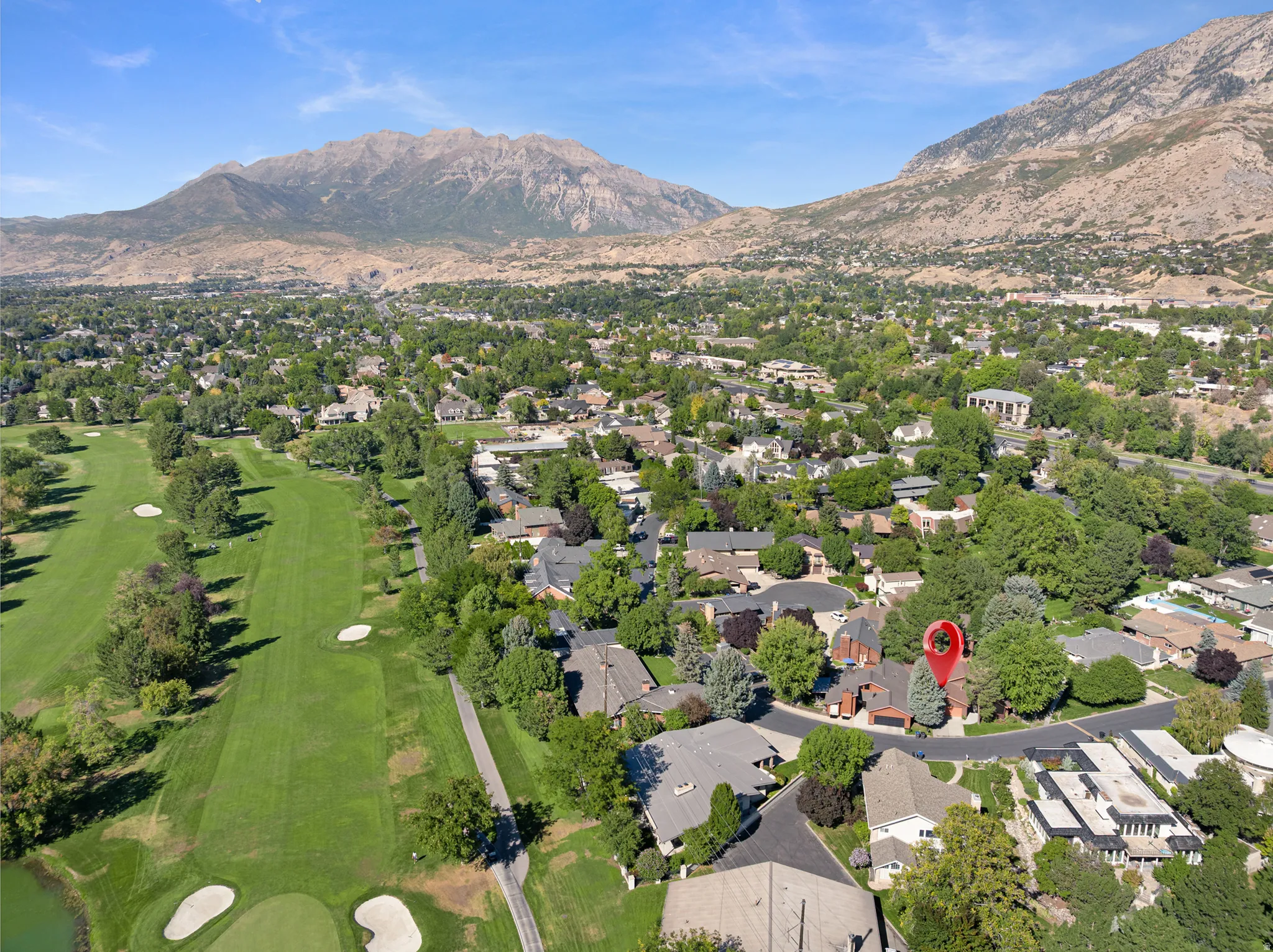 Residential area with established landscaping, adjacent to golf course fairways