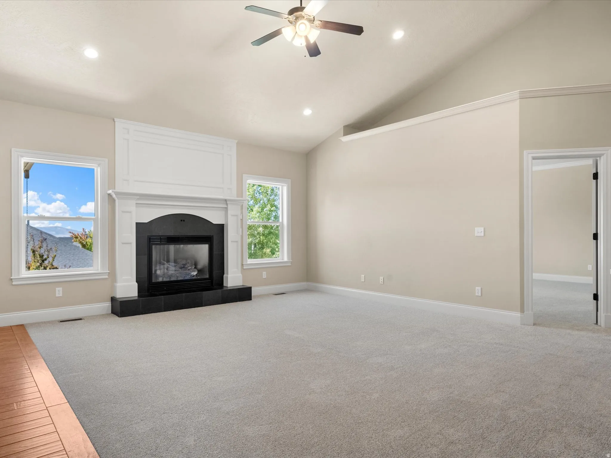 Vaulted ceiling with recessed lighting and ceiling fan