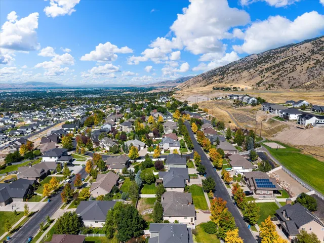 Neighborhood setting with mature trees and a distant mountainous backdrop