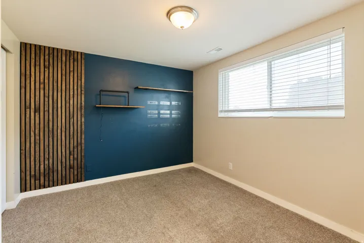 Accent wall with vertical wood paneling and a deep blue finish