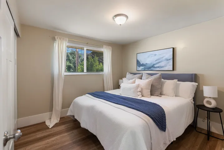 Wood-finish flooring, recessed lighting, and a window with natural light