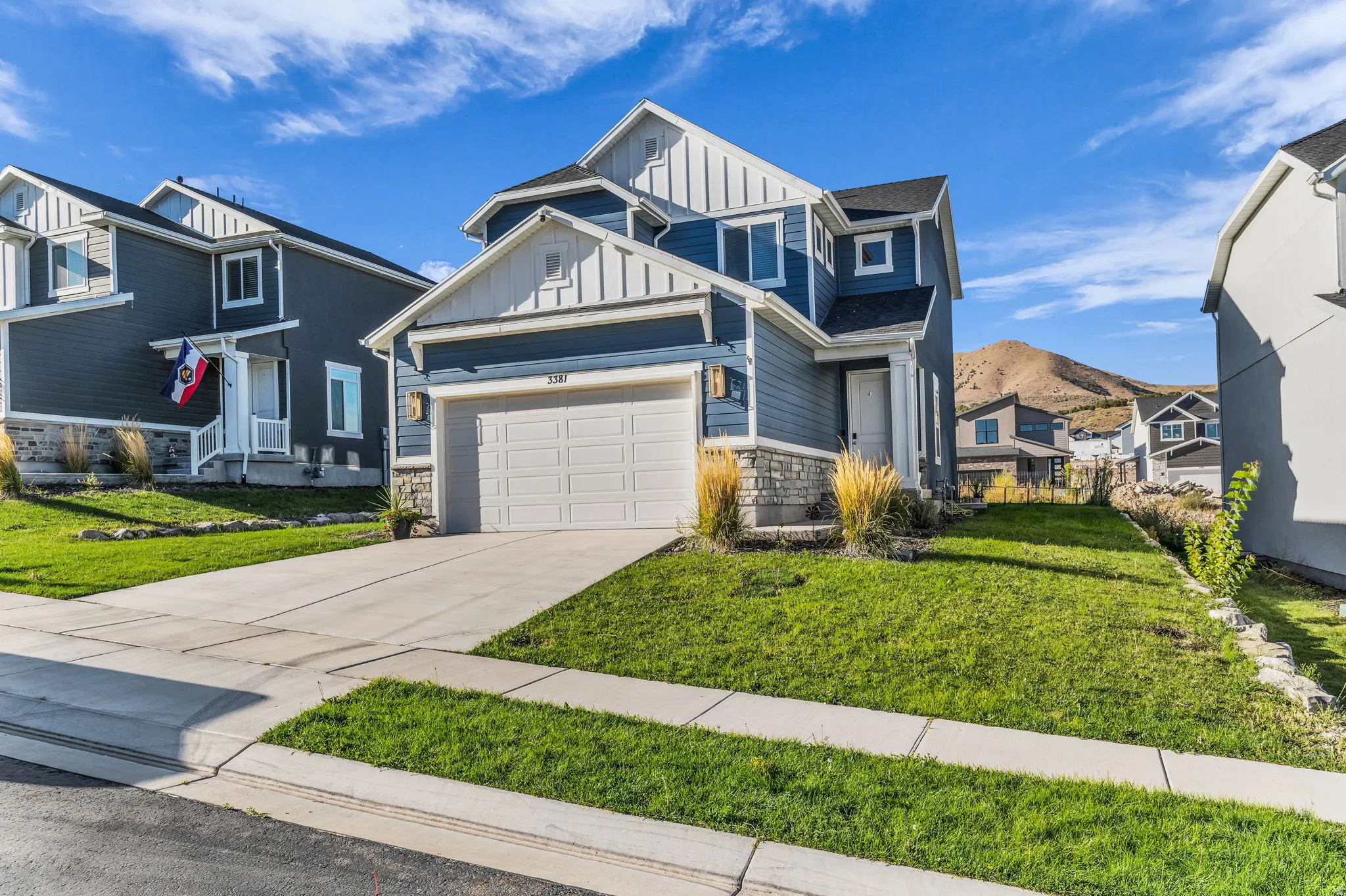 Contemporary two-story residence featuring blue siding and white trim
