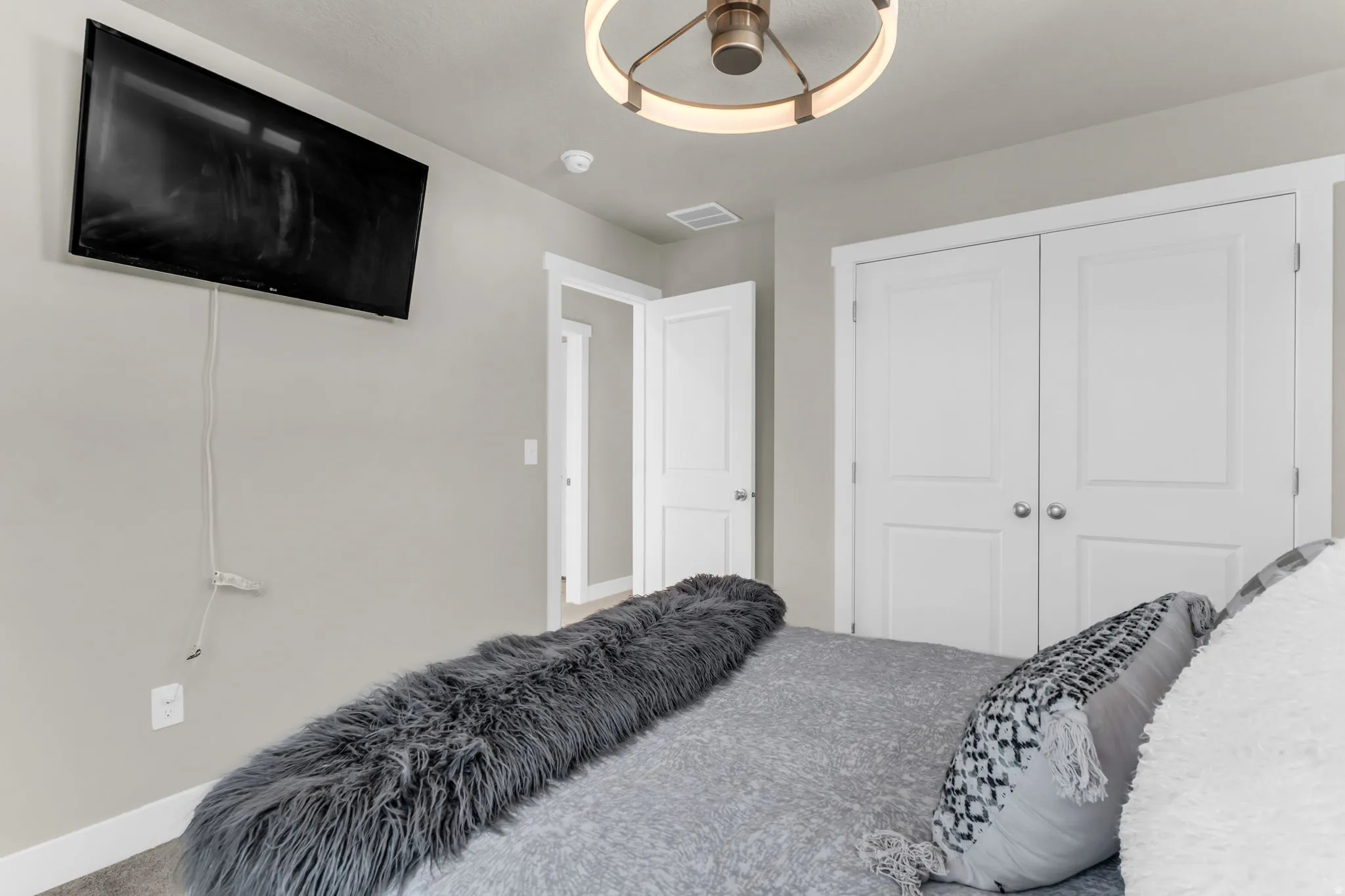 Interior space featuring light gray wall paint, white trim, and a contemporary ceiling light fixture