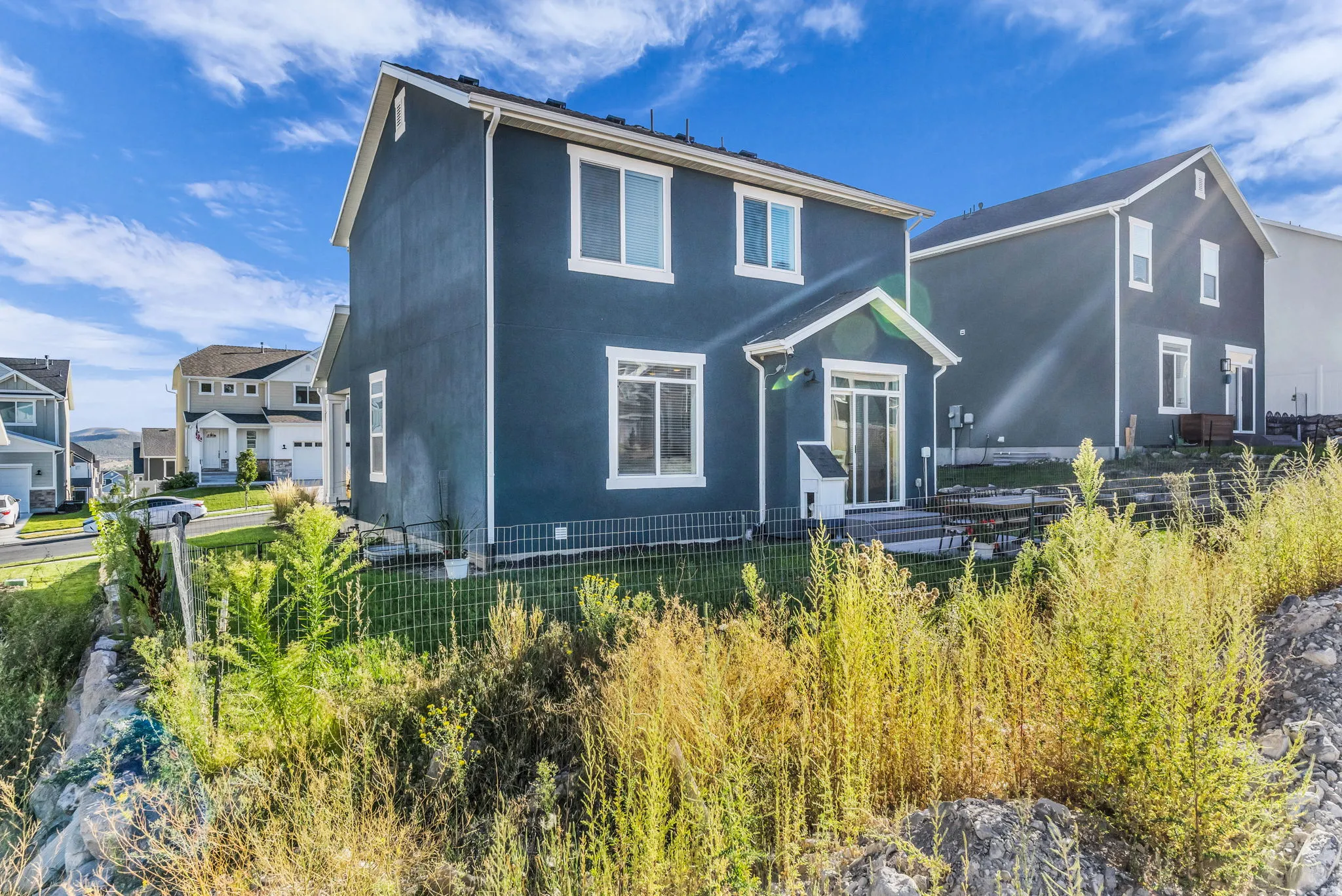 Two-story exterior with dark siding and white trim