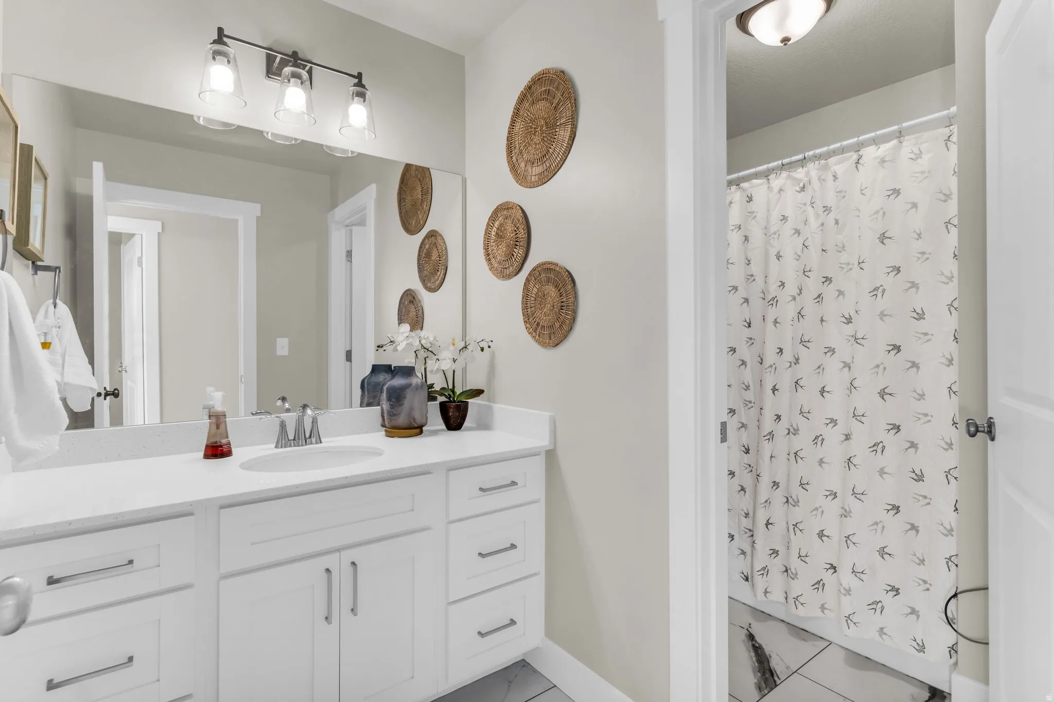 White vanity with extensive countertop space, under-mount sink, and contemporary hardware