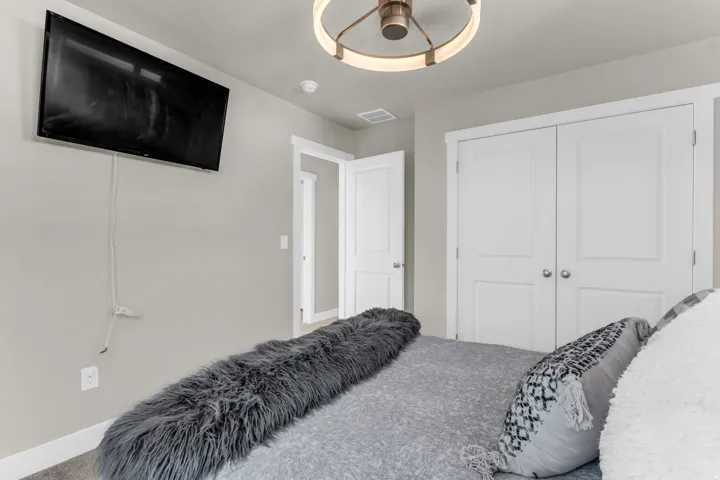 Interior space featuring light gray wall paint, white trim, and a contemporary ceiling light fixture