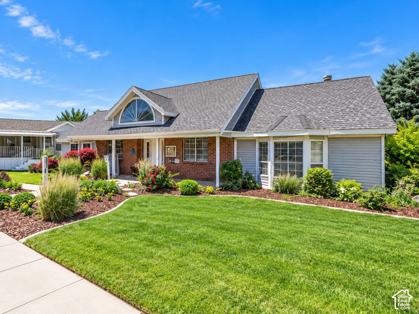 Brick and siding exterior with a gabled roofline