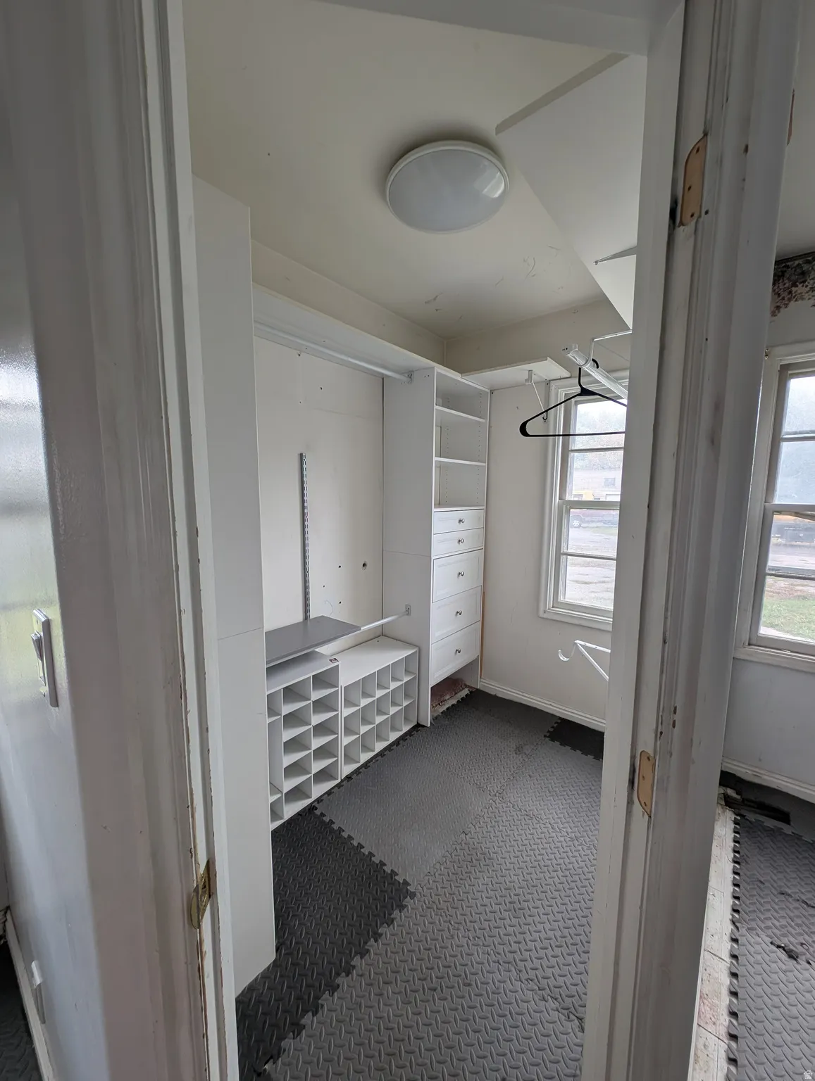 Built-in shelving, integrated drawers, and dedicated shoe organizers provide comprehensive storage solutions