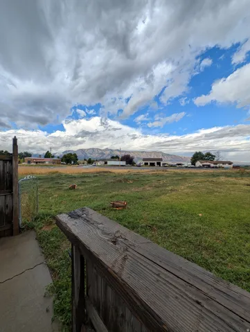 Expansive open lot with a mountain backdrop
