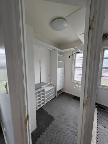 Built-in shelving, integrated drawers, and dedicated shoe organizers provide comprehensive storage solutions