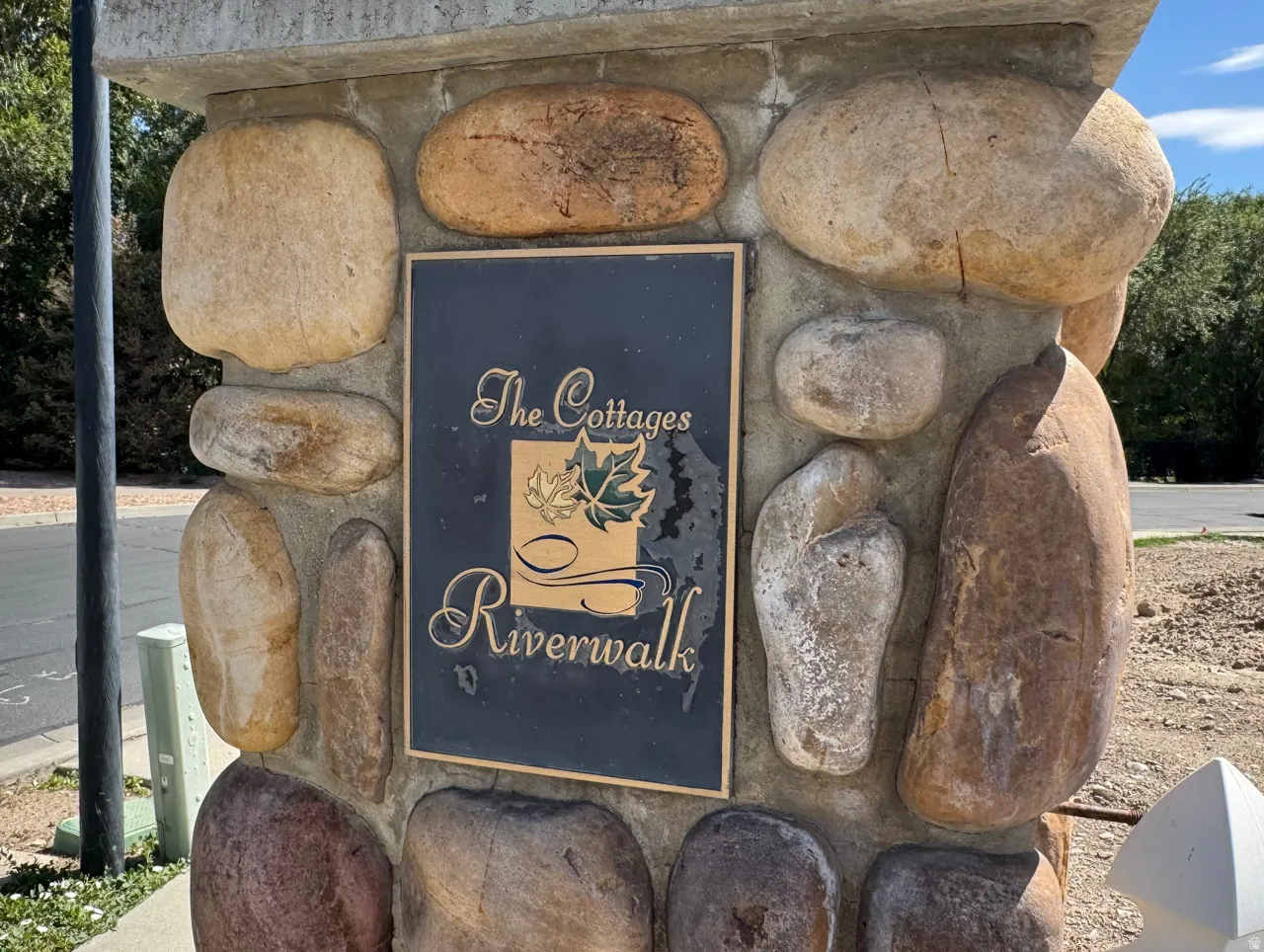 Stone pillar with a bronze-finish sign