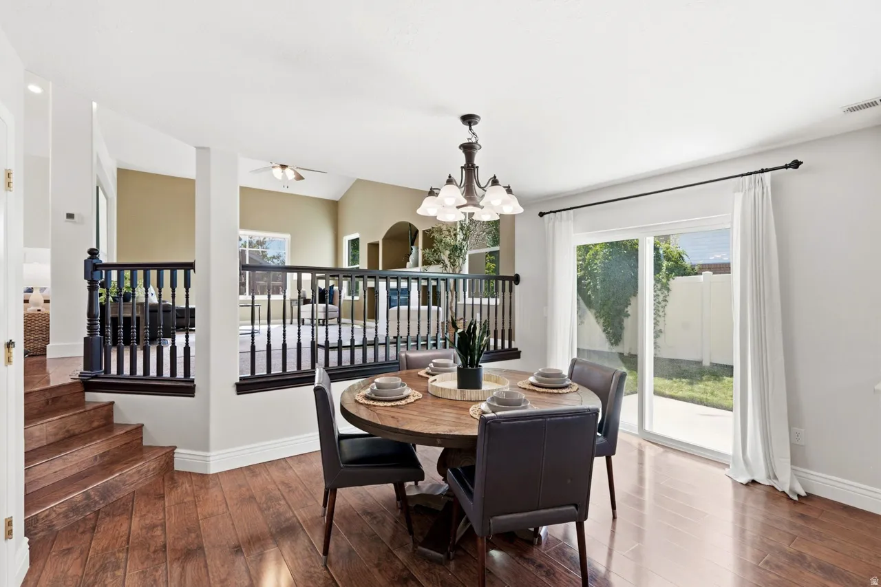 Wood-finish flooring, recessed lighting, white walls, and a sliding glass door to an outdoor area