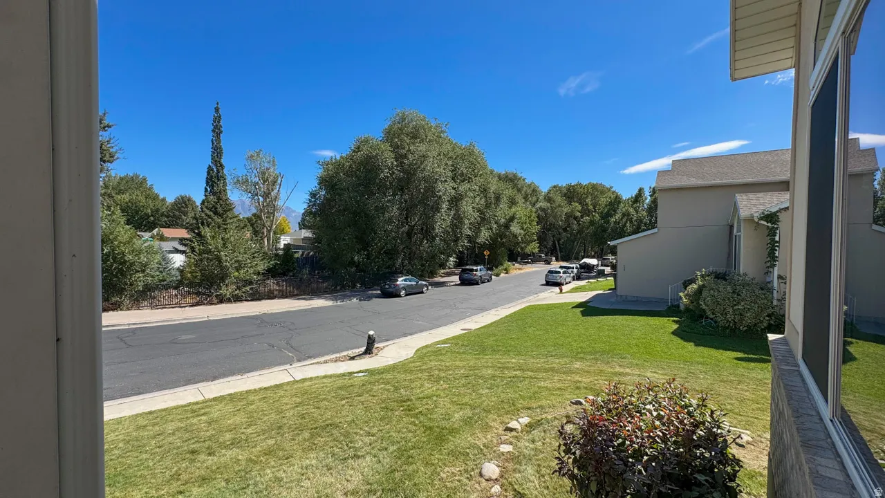 Manicured lawn with established landscaping and mature trees