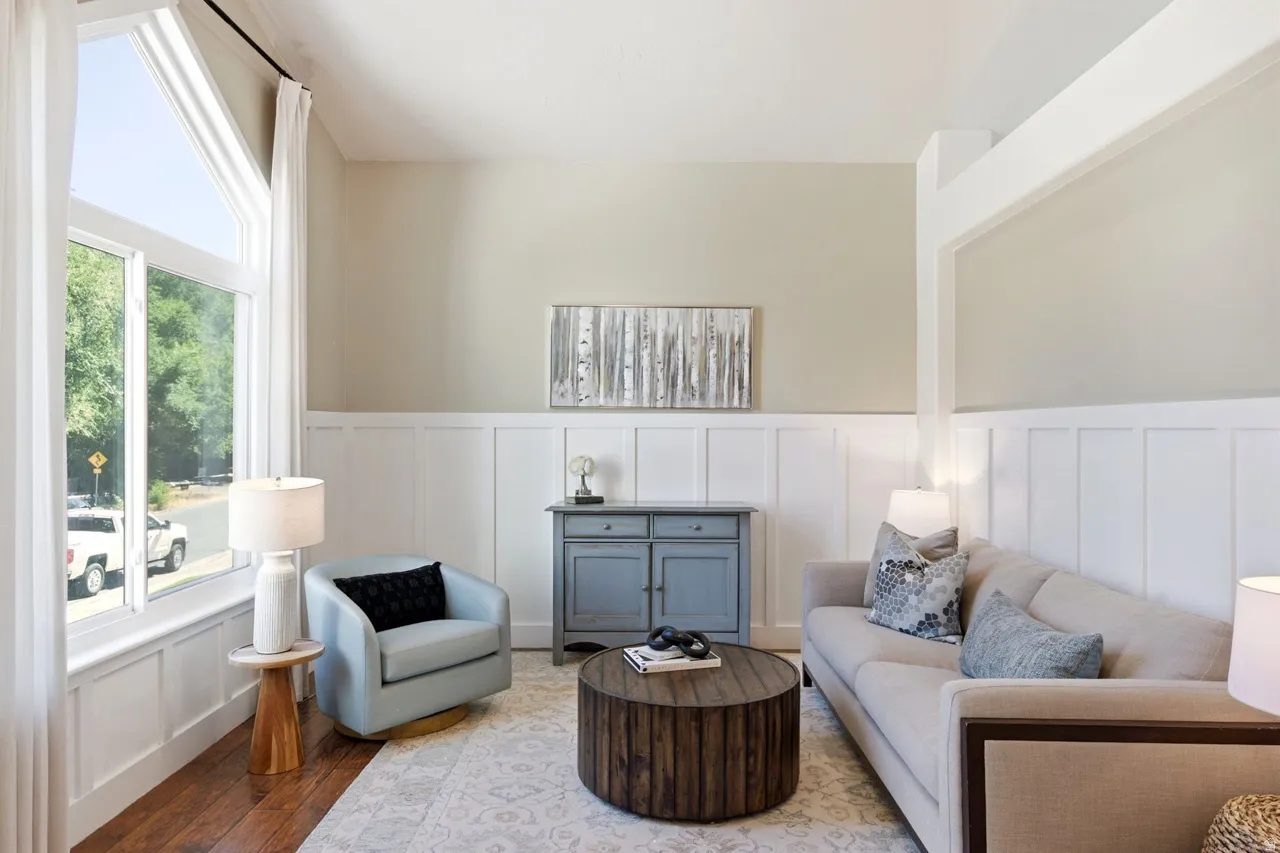 Hardwood flooring, tall windows, white wainscoting, light neutral wall colors, and recessed lighting