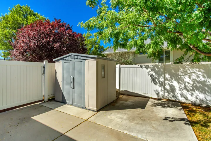 Outdoor storage shed with dual gray doors