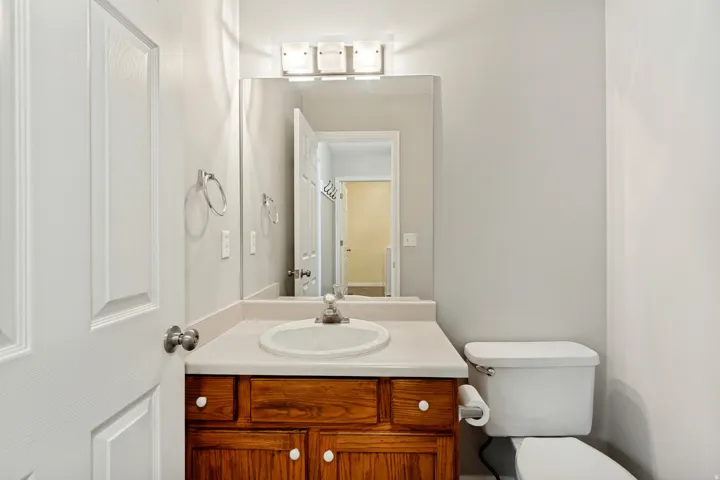 Wood-finish vanity with an integrated sink and light countertop
