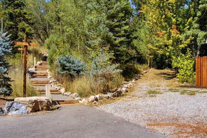 Gravel and paved driveway areas with a stone-lined pathway