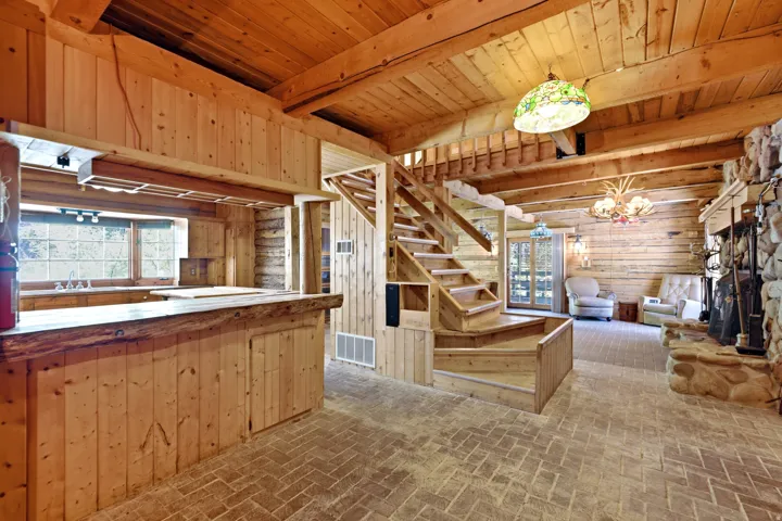 Exposed wood beam ceilings, log walls, and wood-finish flooring