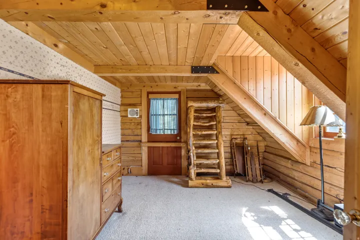 Wood-paneled ceilings, natural wood walls, and a wood-paneled door with a window