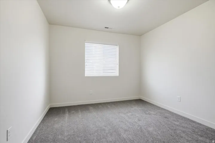 Light gray painted walls with gray carpeting