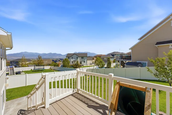 Rear deck with wood-finish decking and white railings