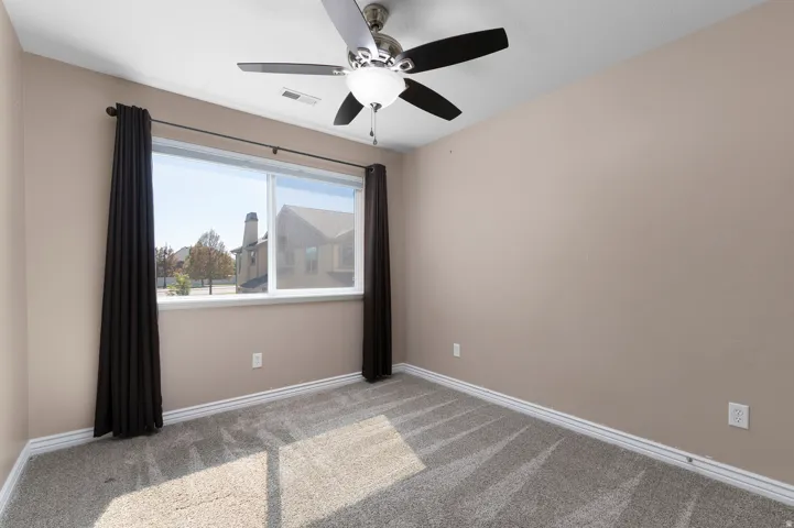 Neutral-toned walls complement the gray carpeting