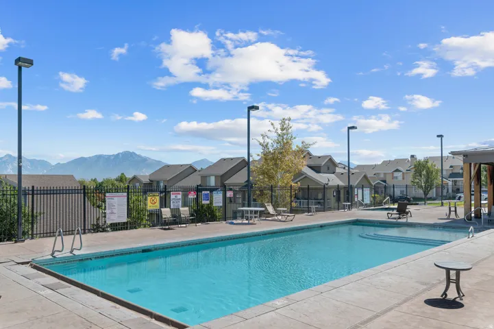 Outdoor swimming pool with integrated steps, surrounded by a concrete deck