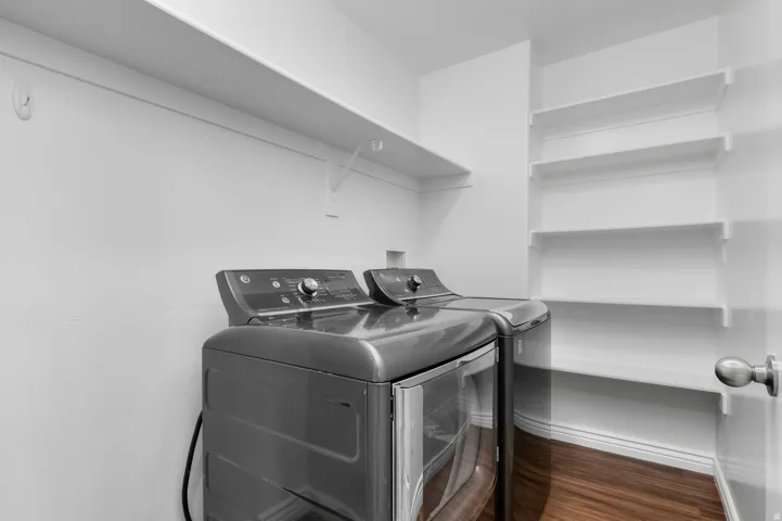 White walls, wood-finish flooring, and built-in shelving
