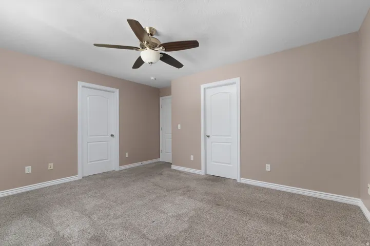 Recessed lighting, ceiling fan with integrated light, two panel interior doors, and neutral wall tones