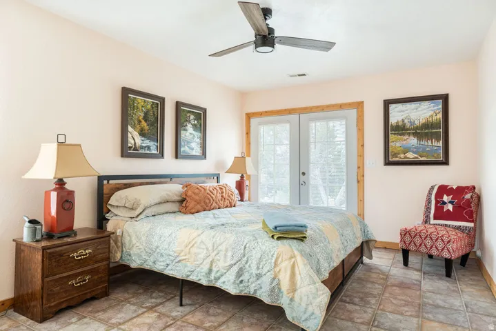 Recessed lighting, ceiling fan, tile flooring, French doors, and wood-finish trim