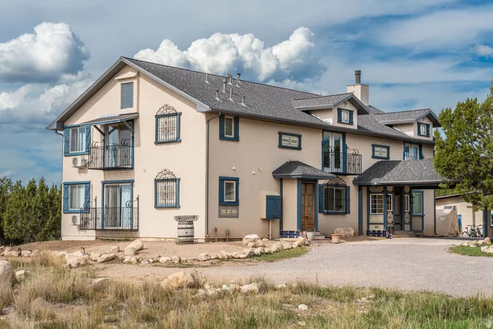 Multi-level stucco exterior with a dormered roofline
