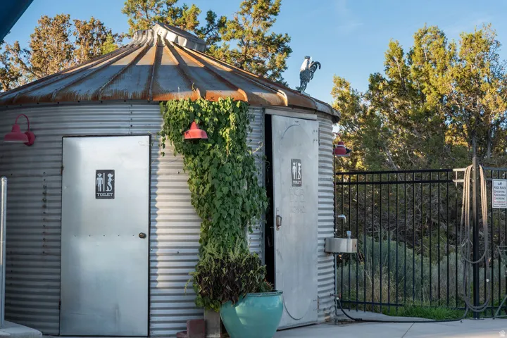 Corrugated metal exterior with a domed metal roof and exterior lighting fixtures