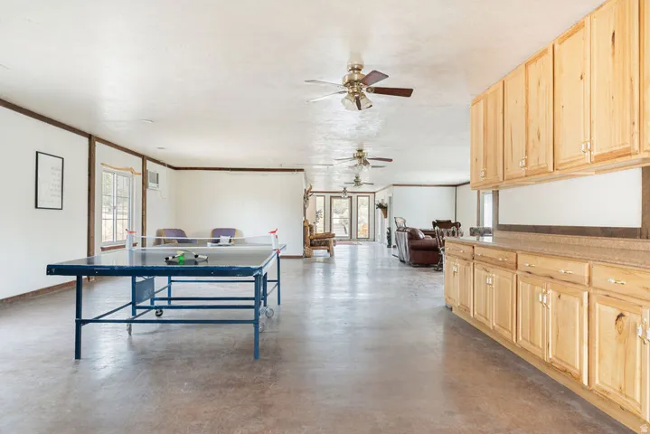 Spacious interior with natural wood cabinetry and a continuous countertop