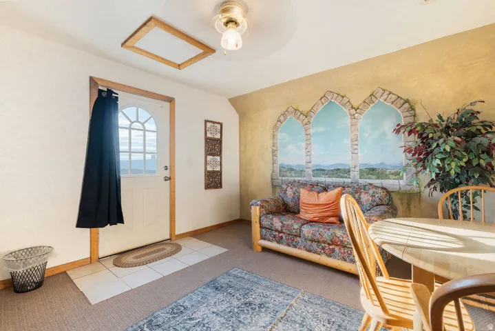 Entryway featuring a white paneled door with an arched window