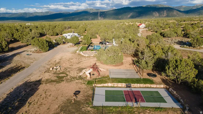 Property featuring an outdoor pickleball court, volleyball court, and a swimming pool