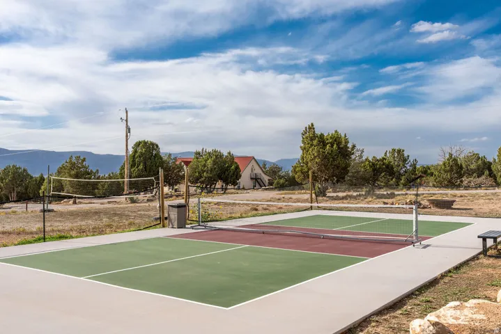 Outdoor multi-sport court featuring green and red playing surfaces