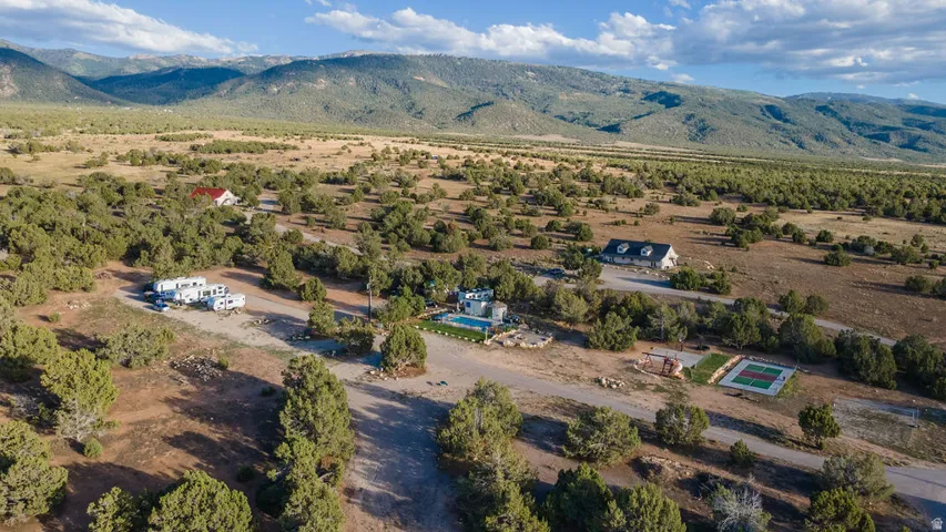 Expansive property featuring multiple structures, a swimming pool, and a dedicated sport court