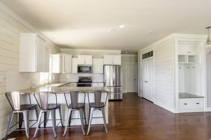 Kitchen featuring white shaker cabinetry, stainless steel appliances, and light-toned countertops